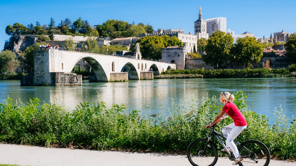 Summer cycling beside Pont Saint Benezet, Avignon, France