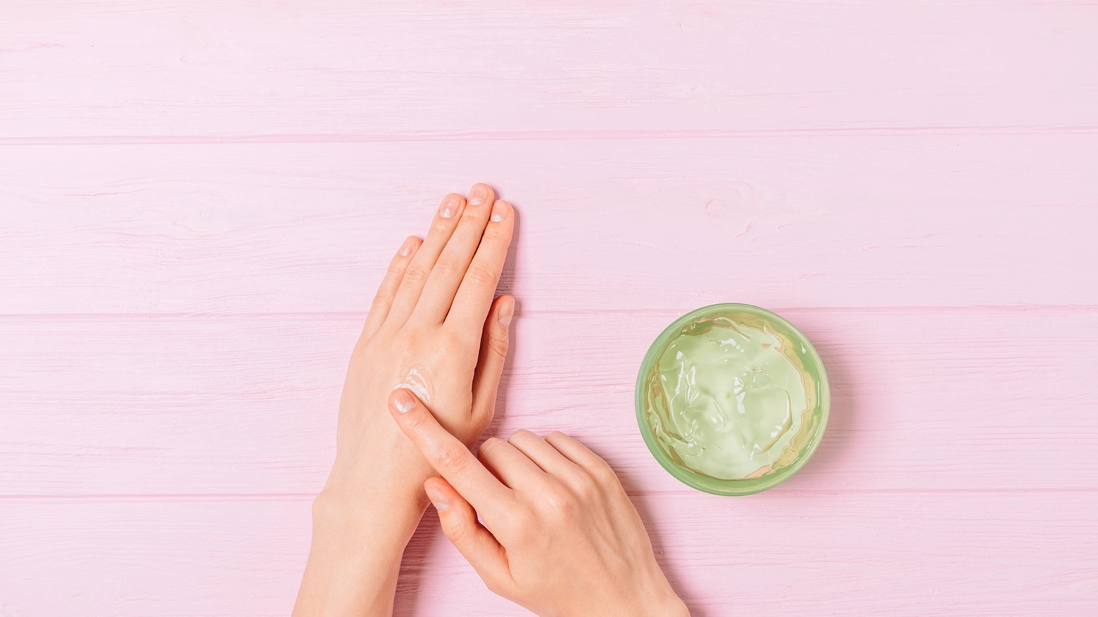 Female hands apply aloe gel on skin