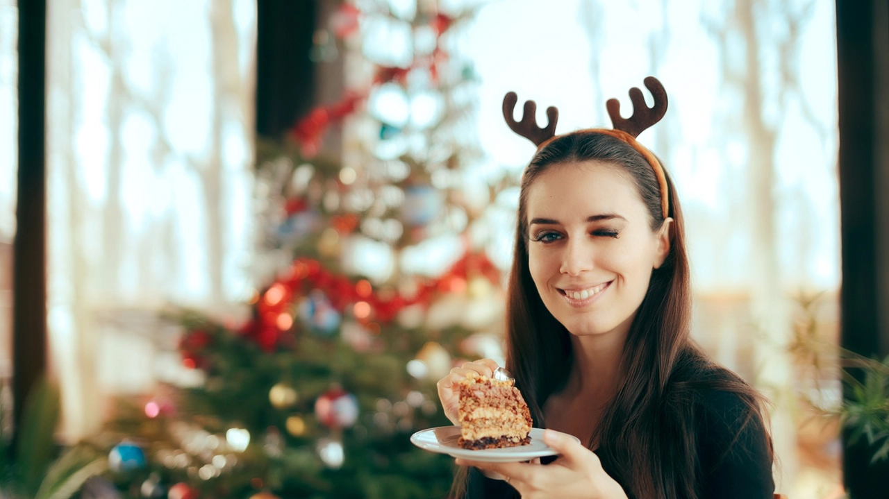 Happy Woman Eating Cake at Christmas Dinner Party