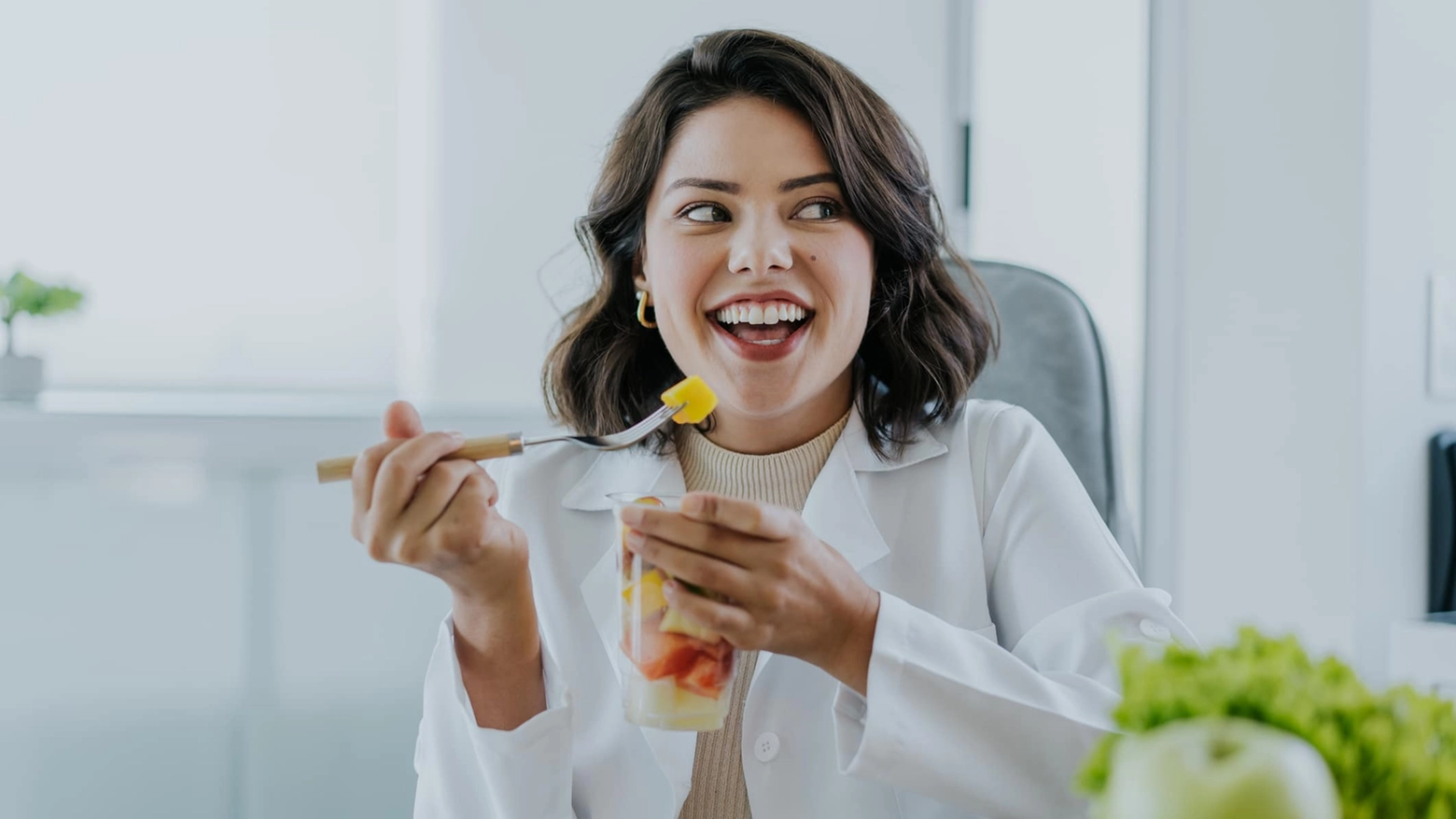 Nutritionist eating fruit salad