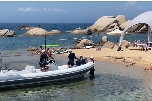 La spiaggia di Talmone invasa da gazebo e campetto da beach volley