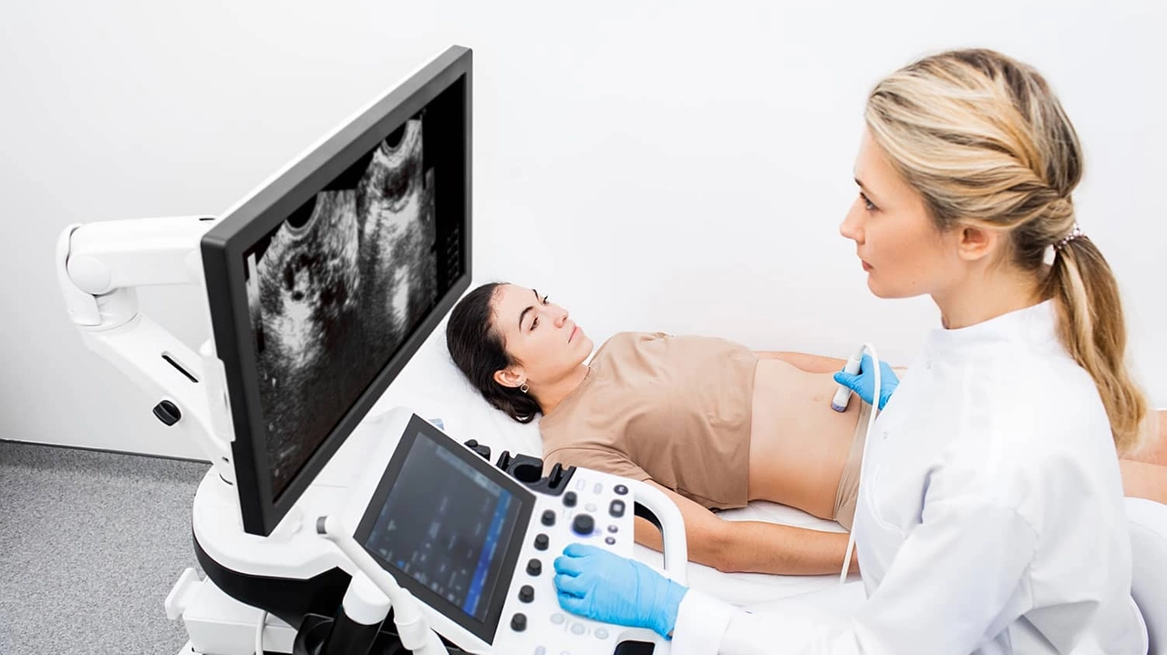 Woman having an ultrasound examination of uterus and ovaries at the gynecologist office in a modern clinic. Women's health