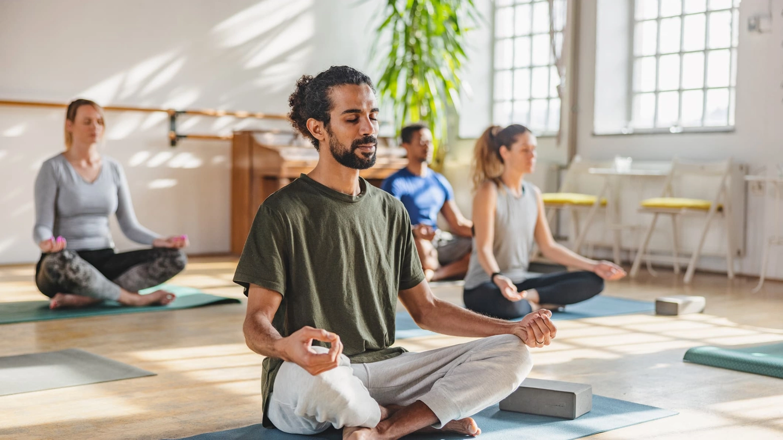 Adult Arab Male With A Ponytail Meditating In A Yoga Class