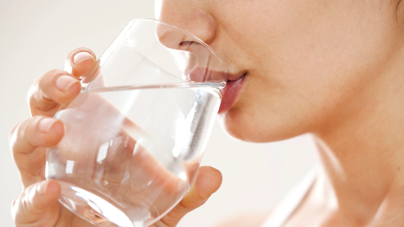 Young woman drinking glass of water